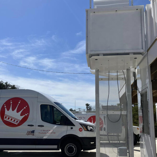 Crown Elevator New Jersey van parked next to newly installed vertical lift to beach house