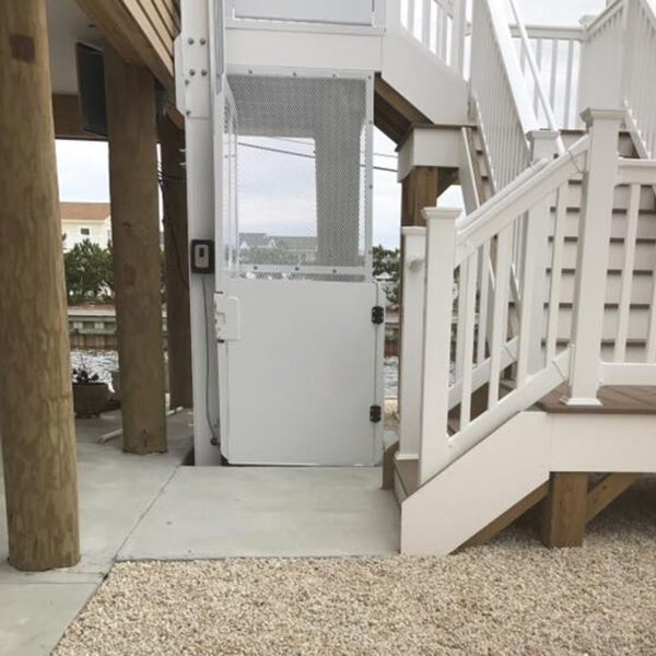 Crown Elevator New Jersey outside vertical lift next to stairway at multi level beach house
