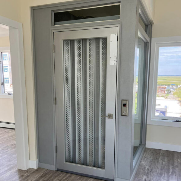 Crown Elevator New Jersey home elevator with metal accordion gates and glass accents