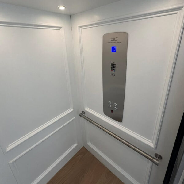 Crown Elevator installation in Avalon NJ raised panel white home elevator with stainless panel