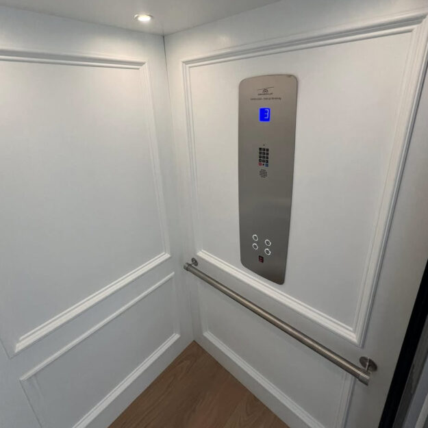 Crown Elevator installation in Avalon NJ raised panel white home elevator with stainless panel