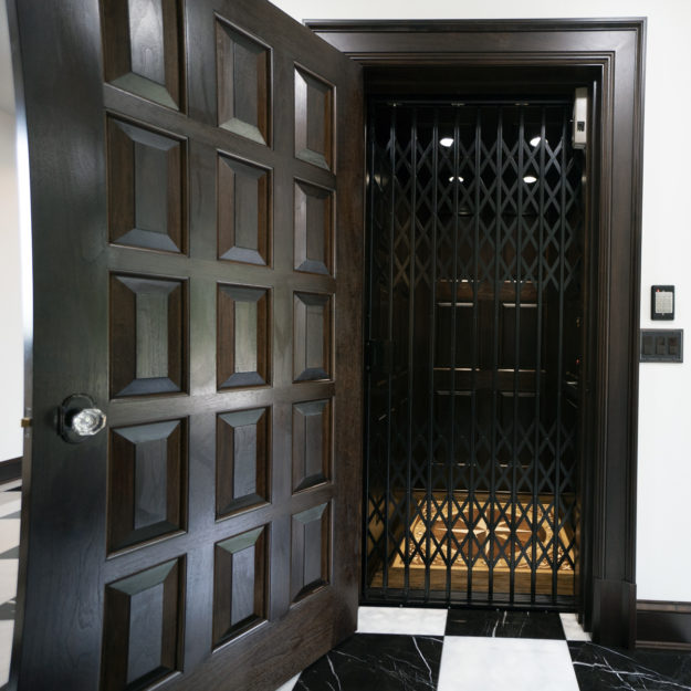 Waupaca residential elevator with custom panel door and floor