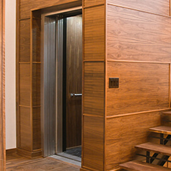 Garaventa Lift home elevator in room with wood paneling